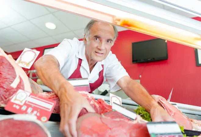 Risques TMS pour les bouchers-charcutiers : position penchée en avant pour attraper les produits