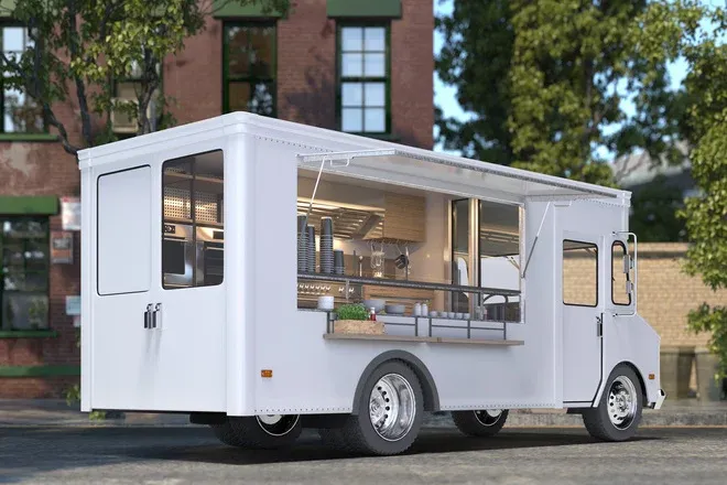 camion magasin blanc ouvert avec comptoir et cuisine de rue garé devant bâtiment